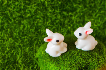 two figures Bunny on the grass. Happy Easter concept