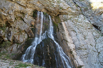 Obraz premium Gegsky waterfall flowing from the cliff in the Caucasus mountains on an autumn day, Abkhazia.