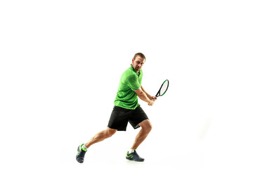 The one caucasian man playing tennis isolated on white background. Studio shot of fit young player at studio in motion or movement during sport game..