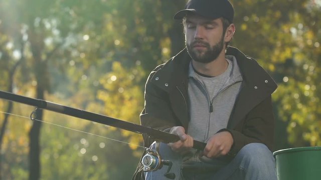 Bored man napping during fishing, morning activity, recreational angling