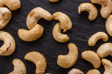 cashew nuts on a dark stone background