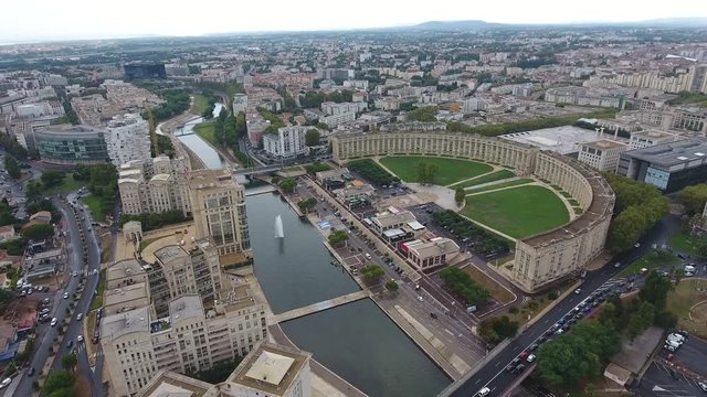 Aerial drone zoom out over Antigone neighbourhood in Montpellier. Semi-circular building architecture France