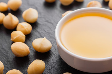 delicious macadamia nuts on a dark stone background