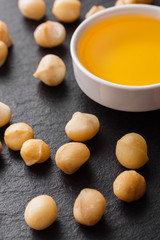 delicious macadamia nuts on a dark stone background