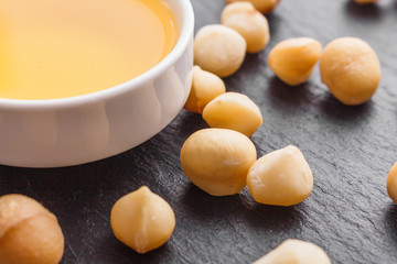 delicious macadamia nuts on a dark stone background