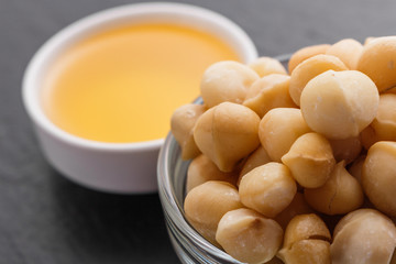 delicious macadamia nuts on a dark stone background