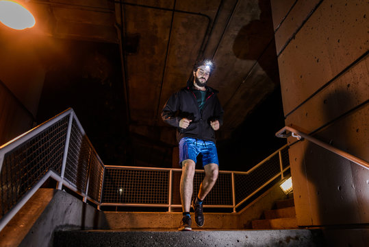 Runner With Headlamp Going Down Stairs, North Vancouver, Canada