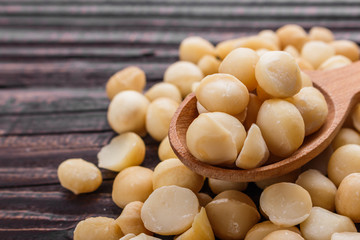 delicious macadamia nuts on a wooden rustic background