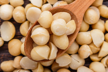 delicious macadamia nuts on a wooden rustic background