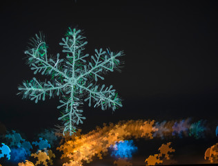 Fototapeta na wymiar snowflake on colorful bokeh background, snowflake with blurred background.
