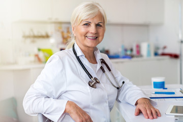 Senior female doctor smiling at the camera