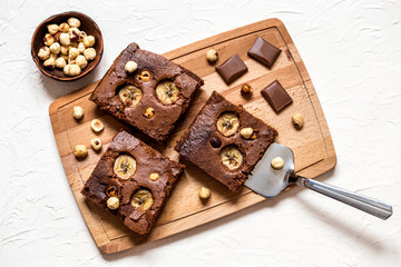 brownie with banana and hazelnut on white background in the form of pieces