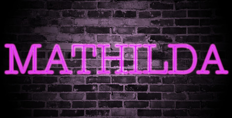 first name Mathilda in pink neon on brick wall