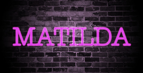 first name Matilda in pink neon on brick wall