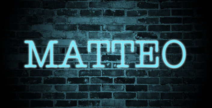 first name Matteo in blue neon on brick wall