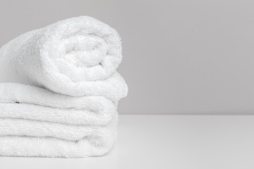 Clean soft towels on color background