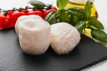 Fototapeta na wymiar Mozzarella tomatoes and basil on a white background