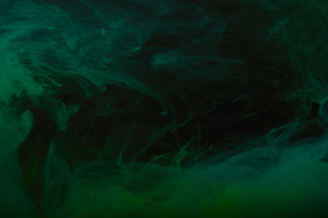 dark texture with abstract green swirls of paint