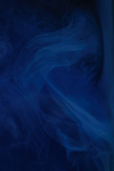 abstract dark texture with blue swirls of paint