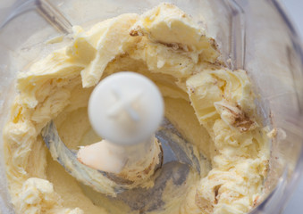 Close up of texture of butter with sugar and cinnamon in blender machine. Сooking desserts. Top view.  