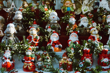 stack of santa claus puppets and statuettes as christmas decorations in winter traditional hadmade market