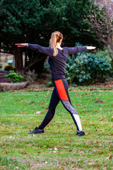 Concept of young lady doing yoga exercises outdoors in the forest