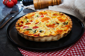 VEGETABLE PIE WITH CHERRY TOMATOES, GRILLED PEPPERS AND COURGETTES With fresh eggs and fresh cream
