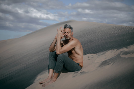 Man sitting on sand dunes