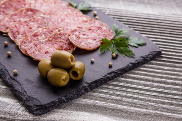 Saucisson sec delicious french salami on a wooden background