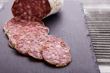 Saucisson sec delicious french salami on a wooden background
