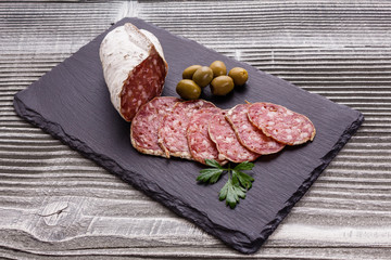 Saucisson sec delicious french salami on a wooden background
