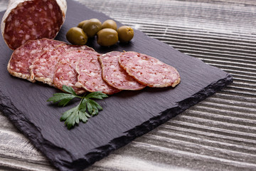Saucisson sec delicious french salami on a wooden background