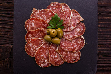 Saucisson sec delicious french salami on a wooden background