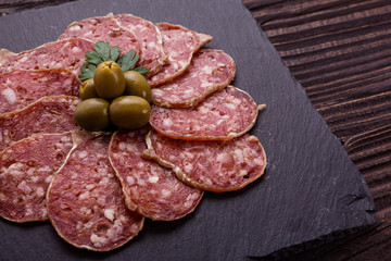 Saucisson sec delicious french salami on a wooden background