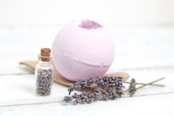 Natural cosmetics. Handmade lavender bath bombs and lavender flowers on white wooden planks