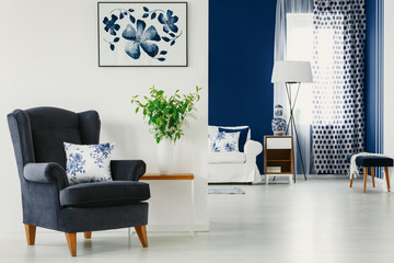 White and blue design in contemporary living and dining room of classy apartment, real photo with...