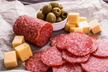 delicious sliced salami on a wooden background