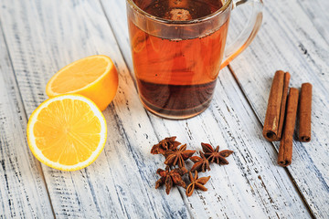 hot tea, cinnamon sticks, star anise, dried tea leaves and orange