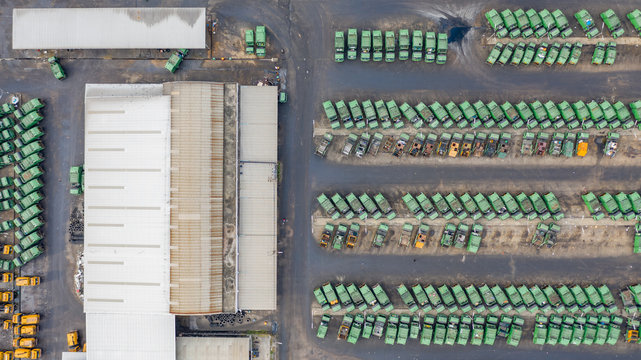 Aerial top view several gabage trucks, cars parked garbage trucks for transport to garbage collection.