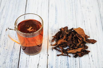 Cup of black tea and tea leaves