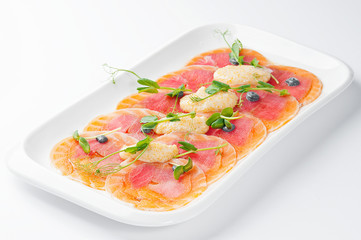Thinly sliced salmon with pike caviar and microgreen