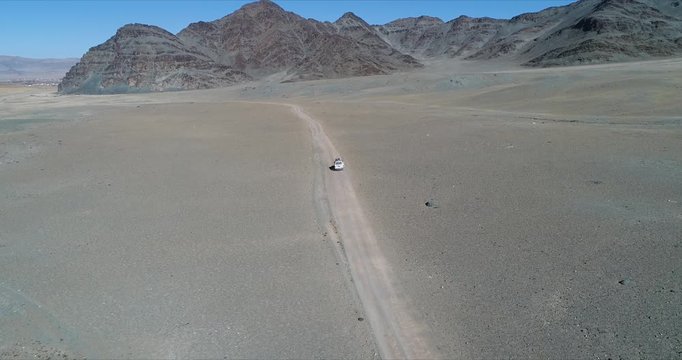 4k 60 fps Mongolia Aerial view of Altai desrt track with 4x4 driving - stopping on track