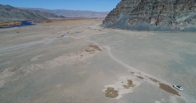 4k 60 fps Mongolia Aerial view of Altai desrt track with 4x4 driving - large above view