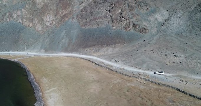 4k 60 fps Mongolia Aerial view of Altai desrt track with 4x4 driving - above river