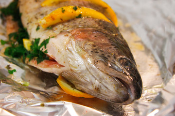 Trout fish filled by orange, herbs and spices and ready to cook