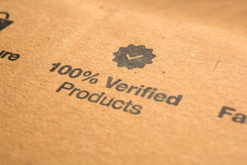 100 percent verified products concept printed on cardboard