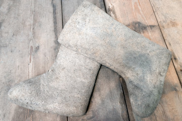felt boots on a wooden floor. Valenki traditional Russian winter footwear in countryside