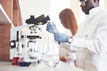 Laboratory laboratories conduct experiments in a chemical laboratory in transparent flasks. Output formulas