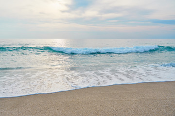 Fototapeta premium Waves with foam hitting sand on the tropical beach texture.
