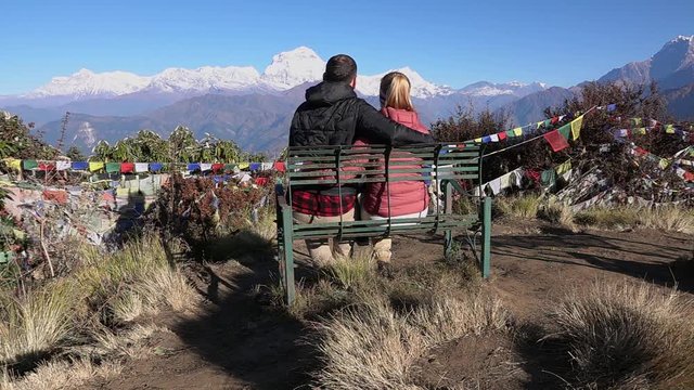Romantic Couple Enjoying the View of the Himalayas. Two Young People Hike Together in Nepal. Active Tourism in the Mountains